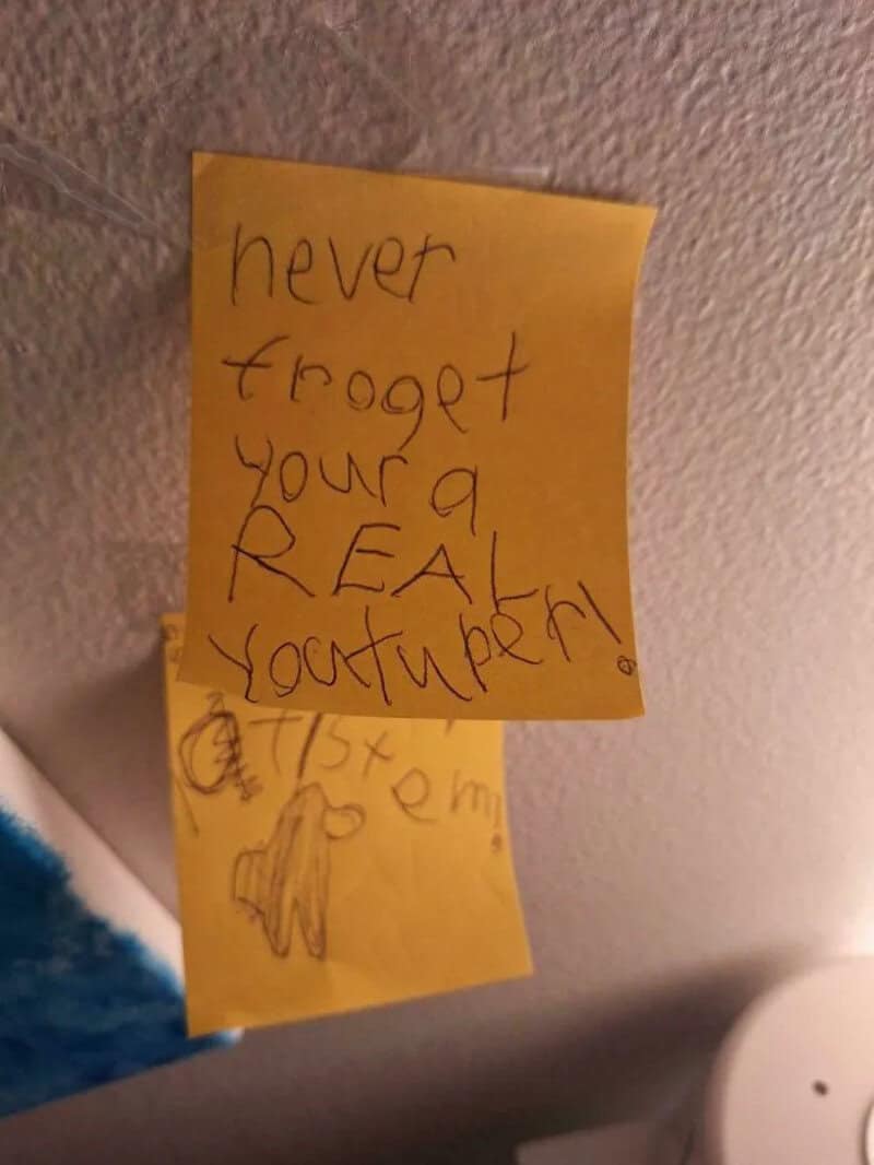 Sticky note with handwritten message: 'never forget your a REAL YOUTUBER!'.