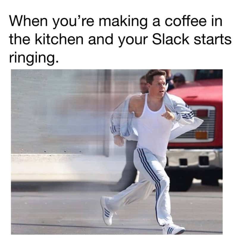 Person running while making coffee in the kitchen, with Slack ringing in the background.