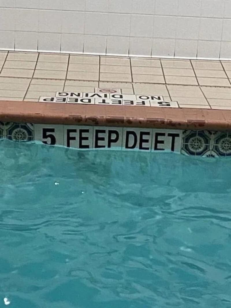 No diving sign with a typo, 'FEEP DEET' instead of 'KEEP DEEP'.