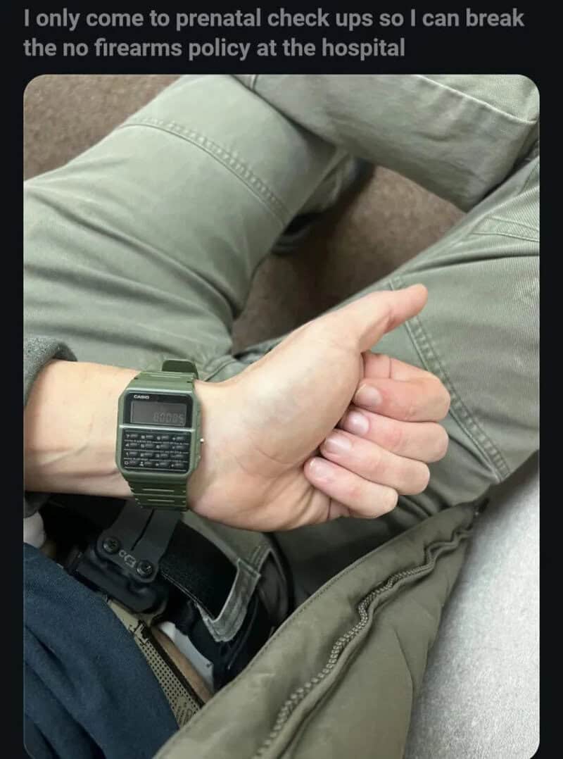 Person's hand with a digital watch resting on their lap, wearing green pants.
