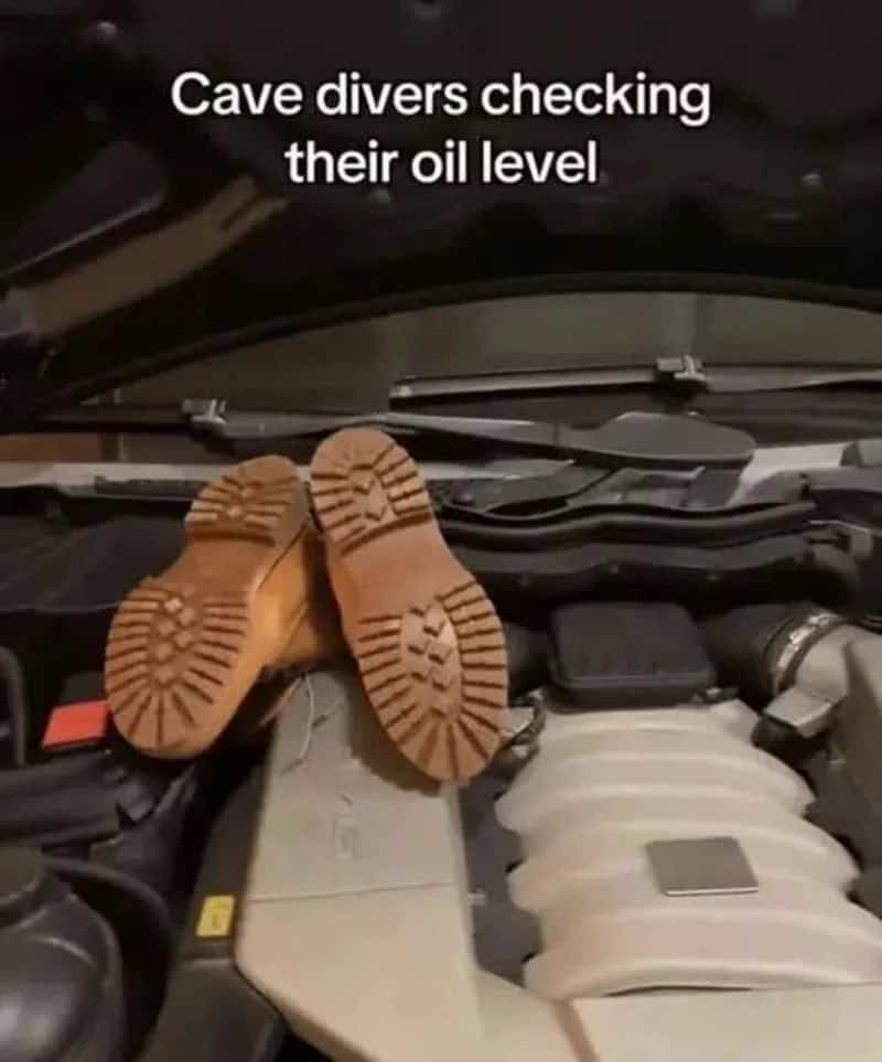 Cave divers checking their oil level with shoes on engine.