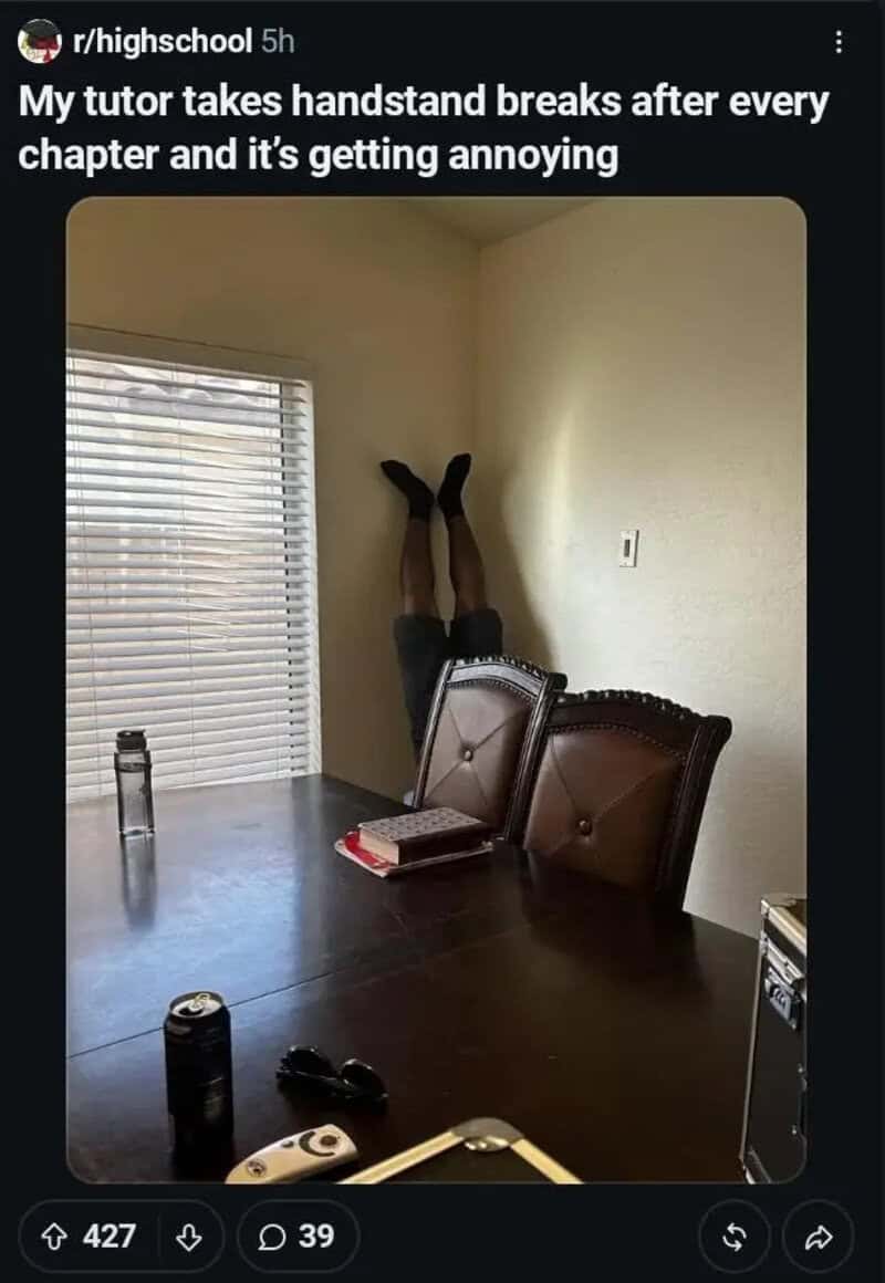 Person's legs up against the wall during a handstand break in a room.