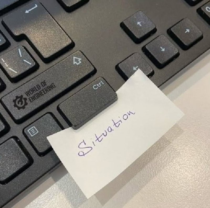 Keyboard with a sticky note that says 'SItuation' covering part of the Ctrl key.