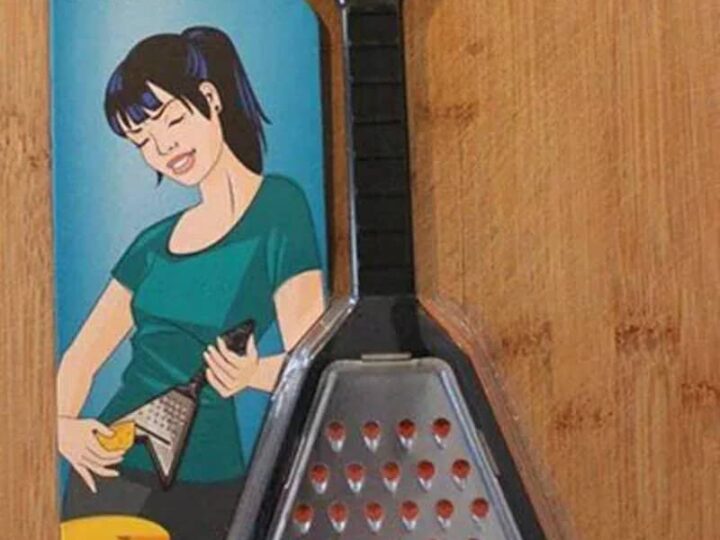 Shredder cheese grater with a triangular shape and a black handle.
