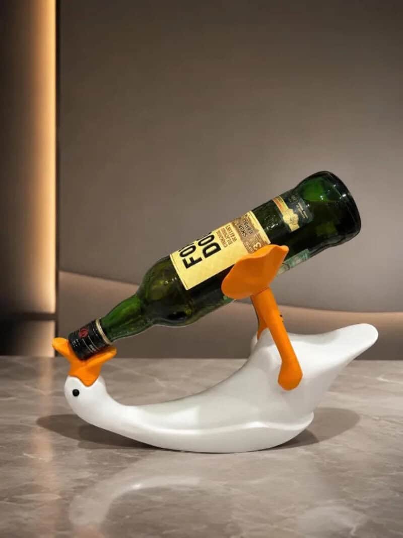 Bottle of Four Loko on a duck-shaped bottle holder with orange legs.