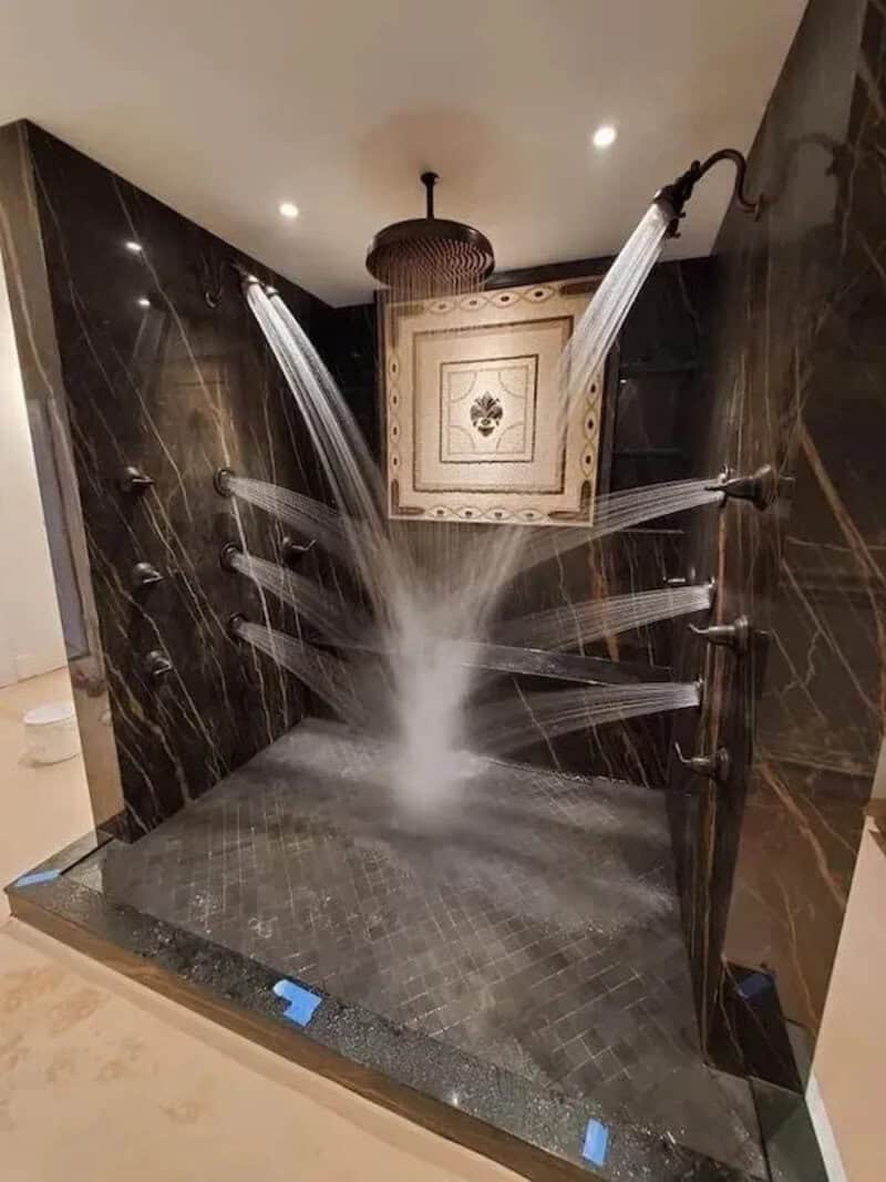 Unique shower with multiple water jets spraying in different directions.