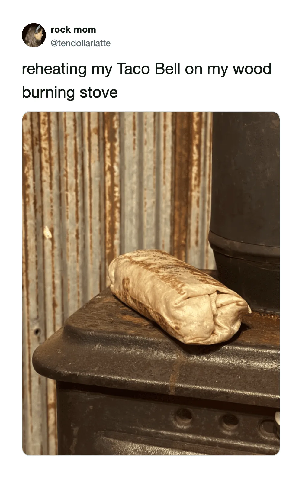 Reheating Taco Bell on a wood burning stove with a burrito on top.