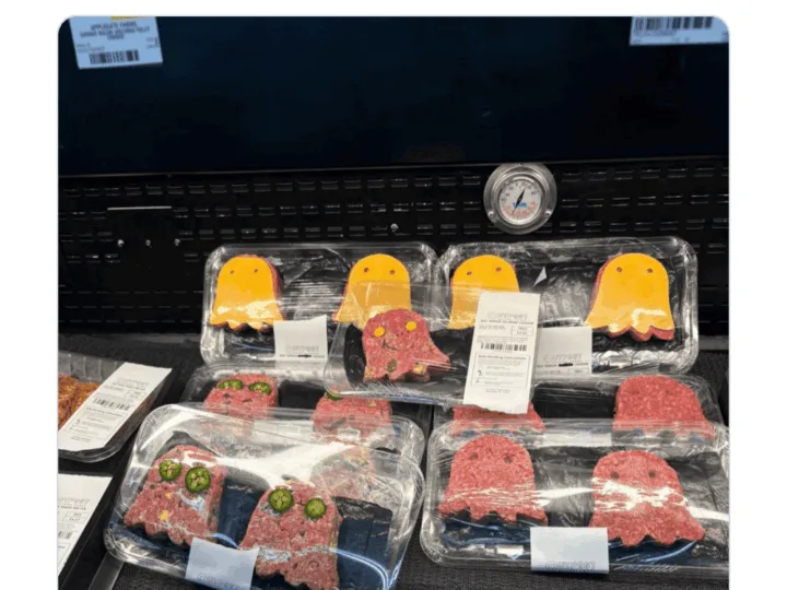 Display of packaged raw meat and burger patties in a grocery store.