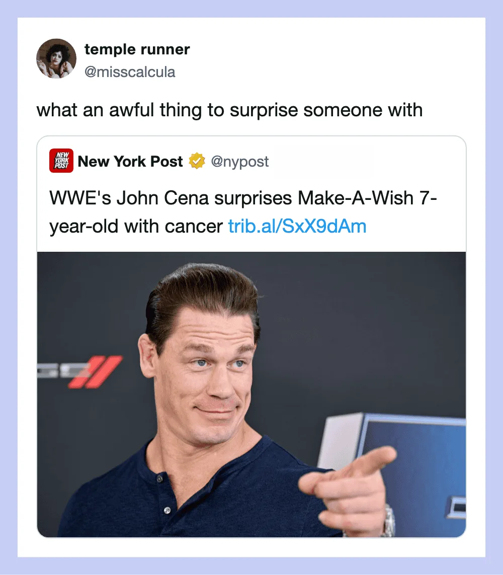 John Cena points with a smirk in front of a dark background.