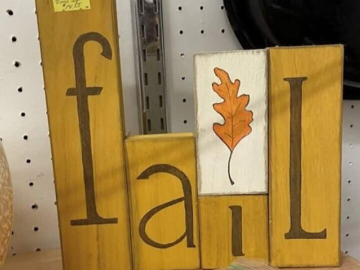 Wooden blocks spell 'fall' with a leaf illustration on one block.