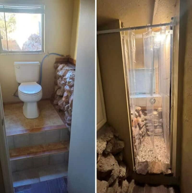 Bathroom with toilet and shower, uneven floor with rocks and construction issues.