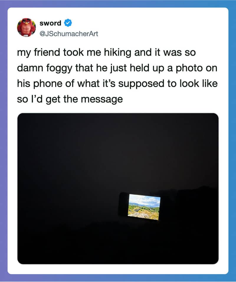 Friend took a foggy hike photo with phone, only screen visible in dark.