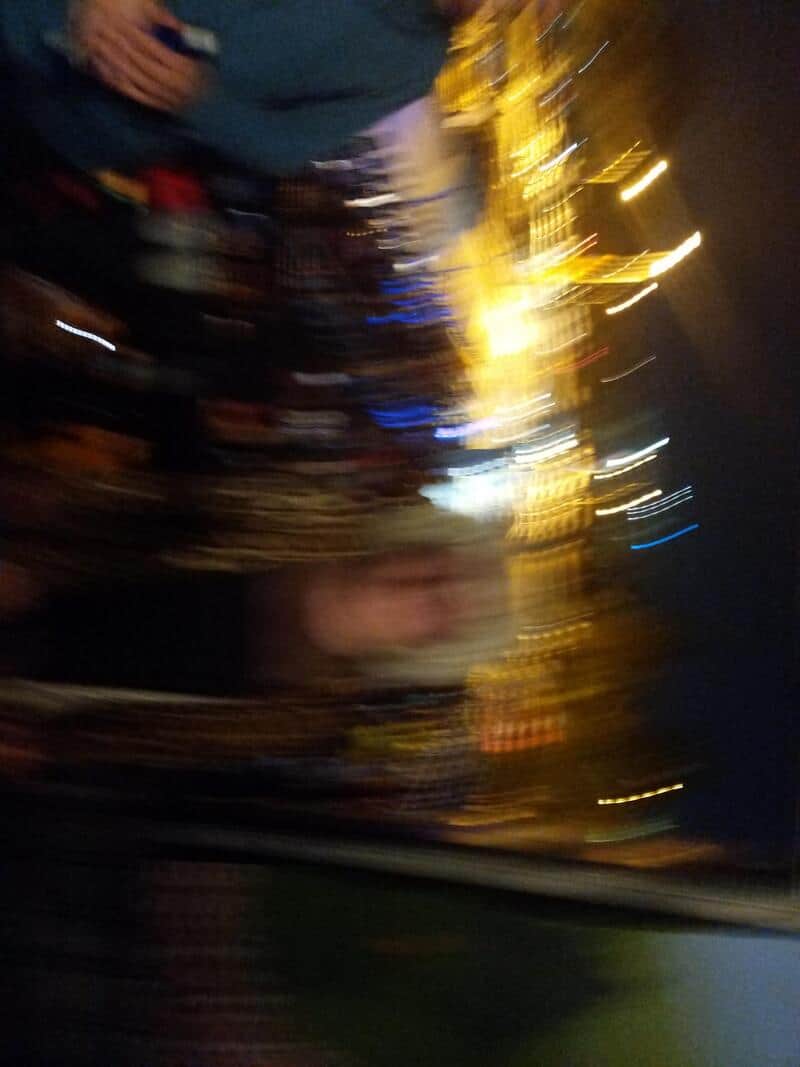 Blurry image of a person with a Halloween mask and decorations.