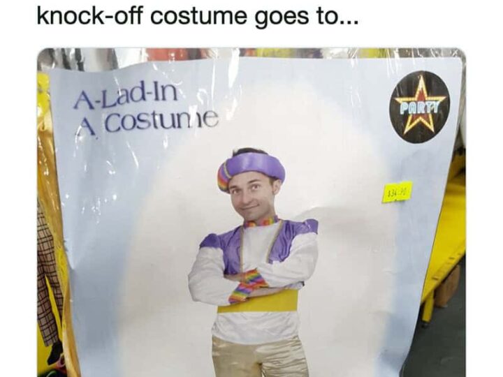 Man in purple and white costume with crossed arms, on a store display.