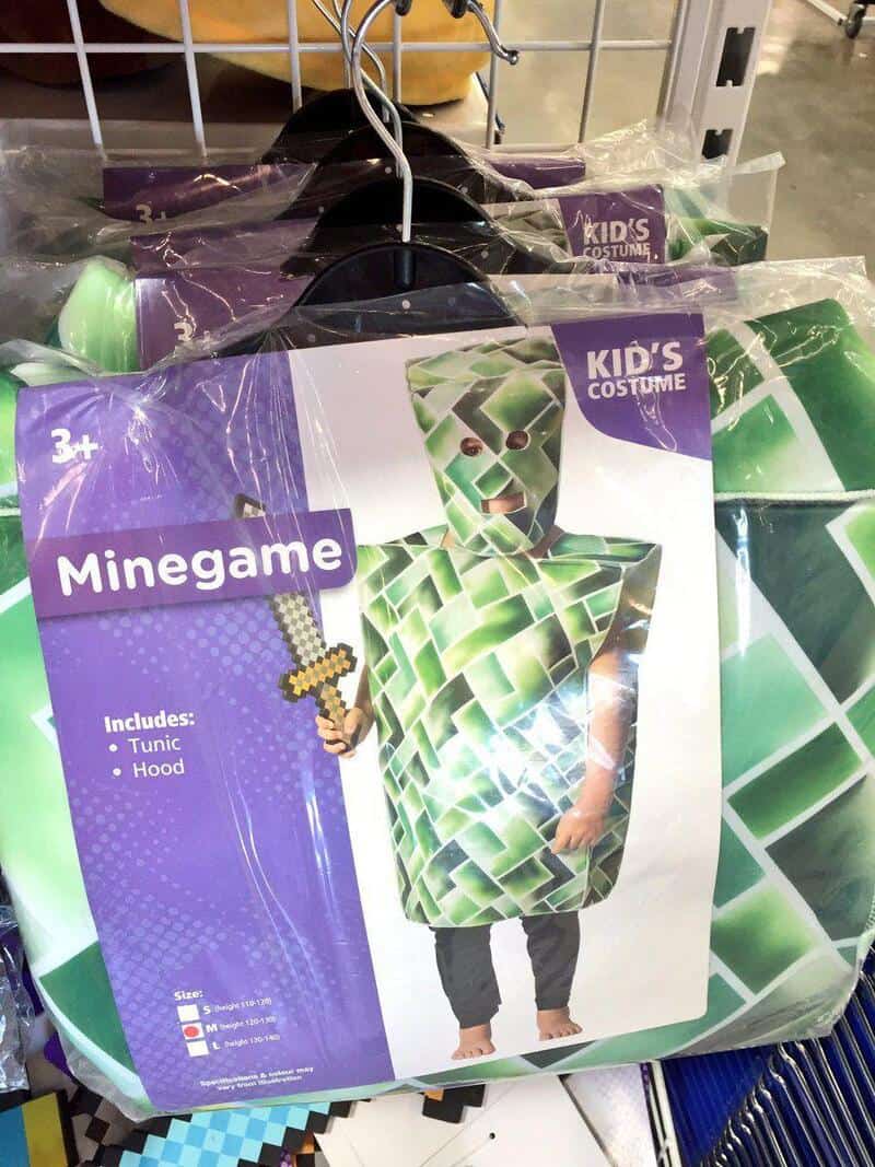Minecraft kid's costume with tunic and hood on display at store.