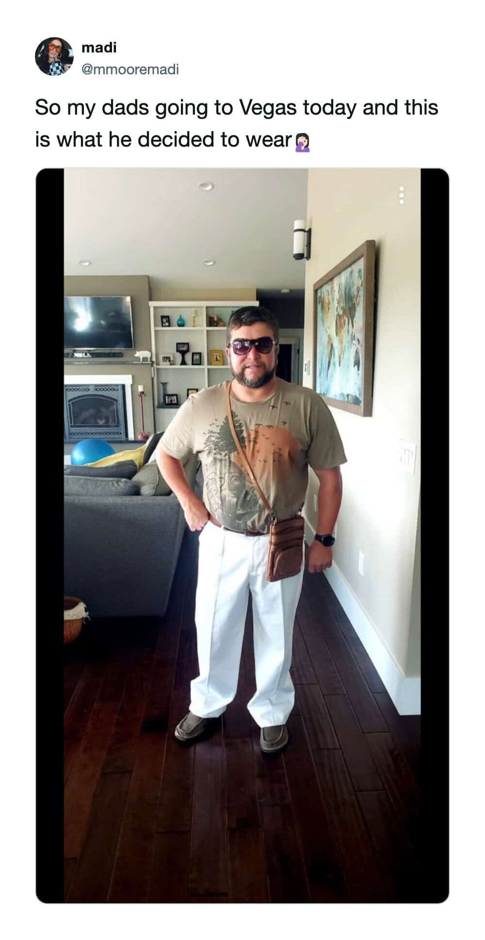 Man in Vegas outfit with sunglasses, beige T-shirt, white pants, and brown bag.