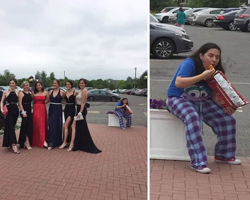 Group of women in formal dresses and a girl in pajamas eating popcorn in a parking lot.