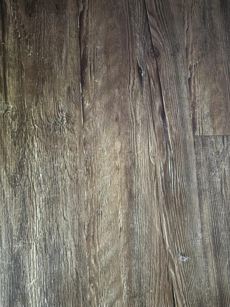 Close-up of weathered wooden planks with visible grain and knots.