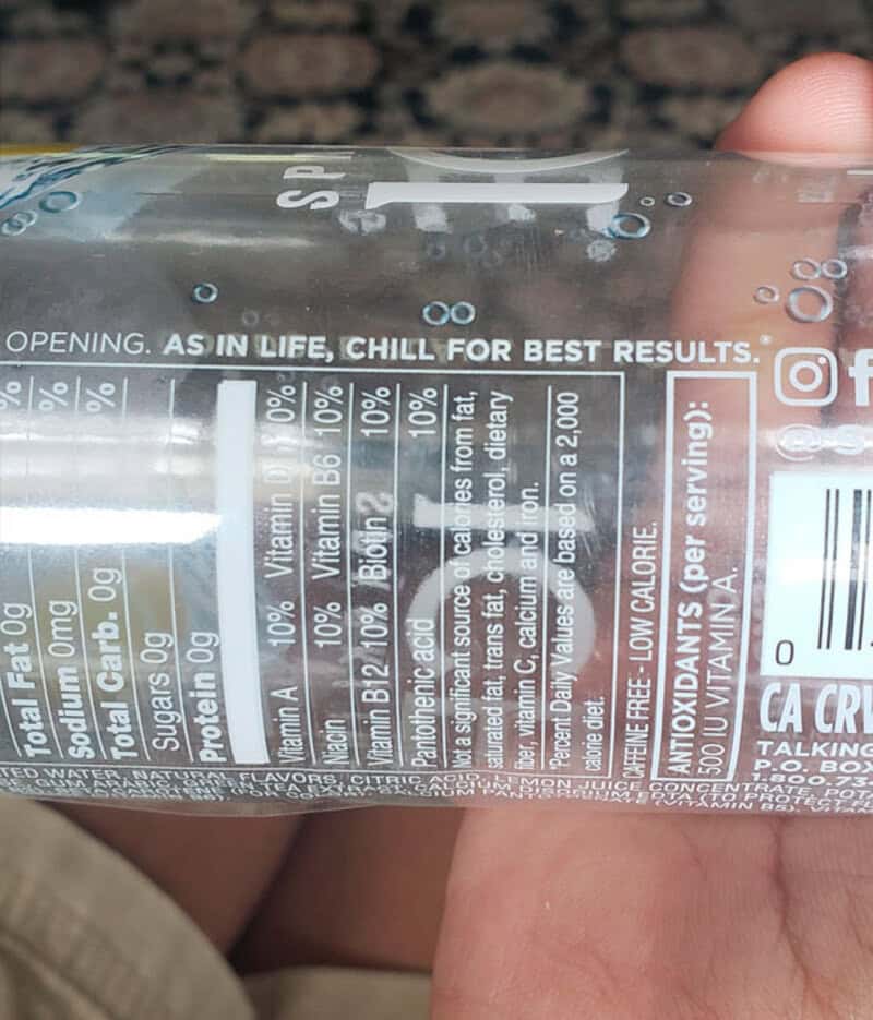 A clear plastic water bottle with a label showing nutritional info and a message.