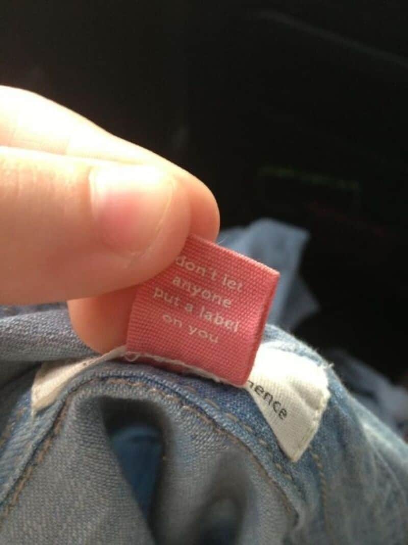 Close-up of a clothing label that says 'Don't tell anyone I put a label on you'.