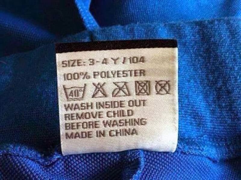 Clothing label with washing instructions and size info.