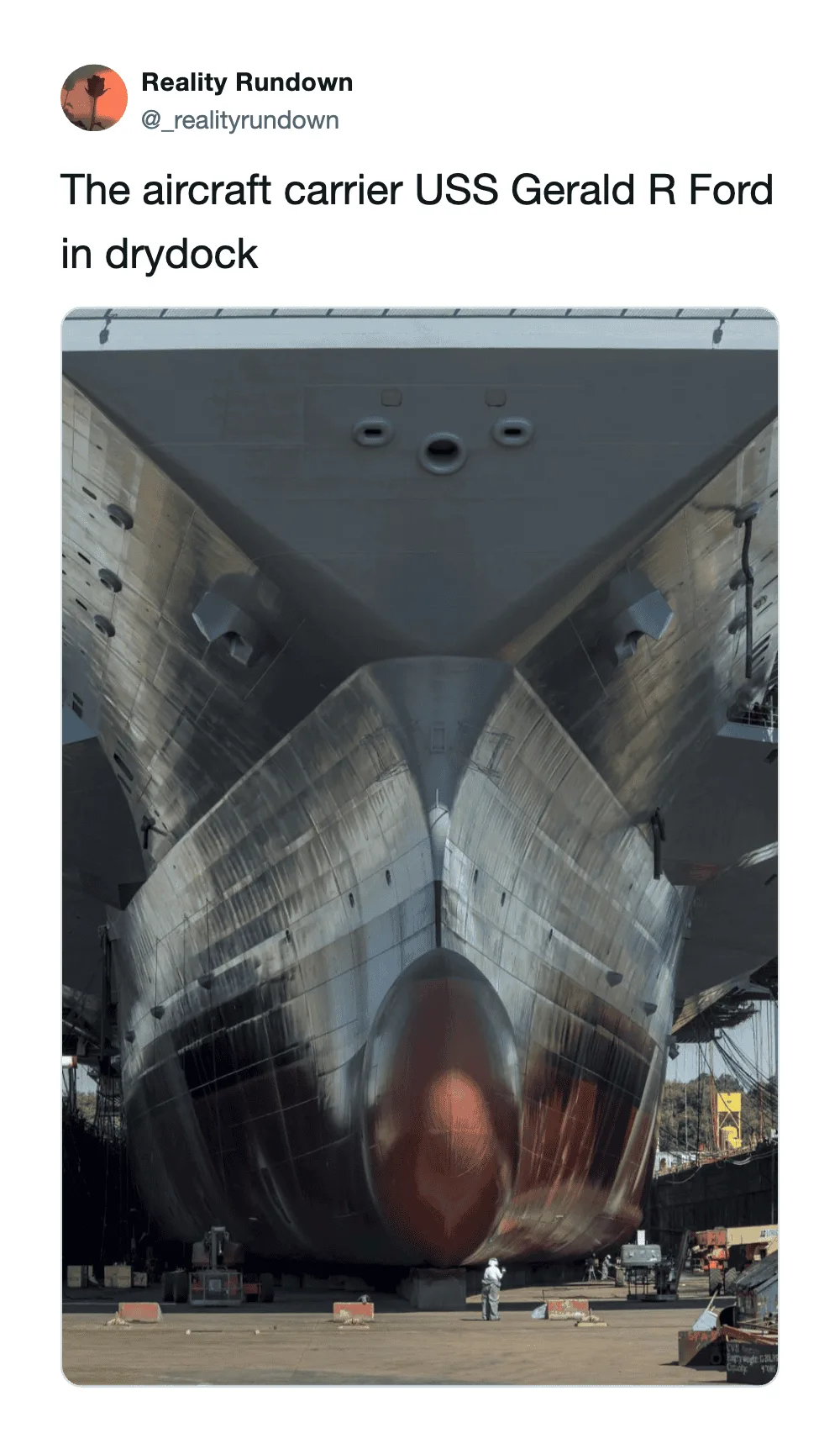 Aircraft carrier USS Gerald R Ford in drydock, viewed from front.
