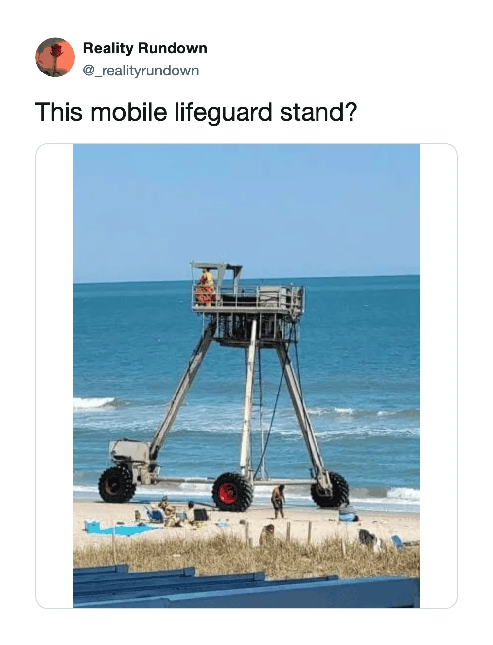 Mobile lifeguard stand on wheels at the beach with people nearby.