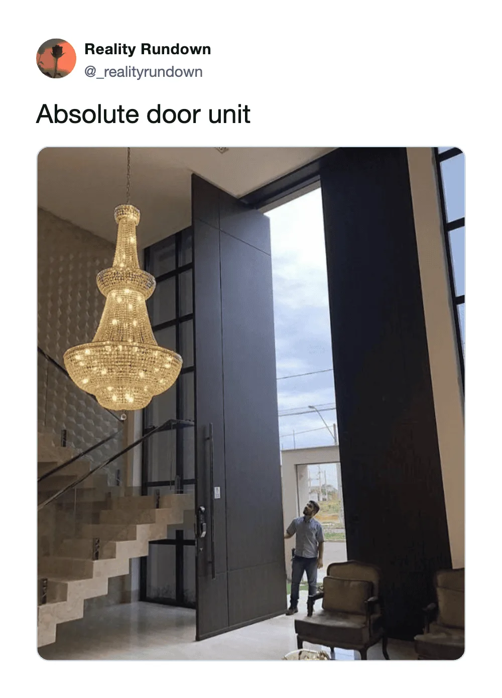 Large door unit with a chandelier and staircase in the background.