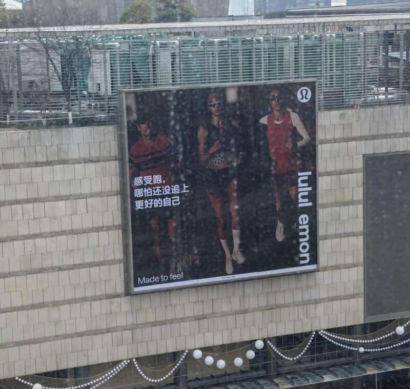 Lululemon advertisement with three models and Chinese text.