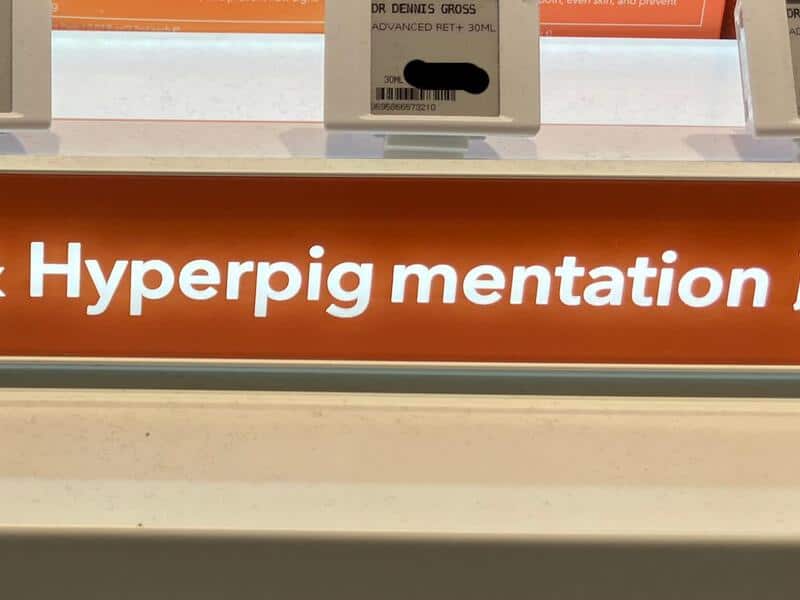 Close-up of a sign with the text 'Hyperpigmentation' in white on an orange background.