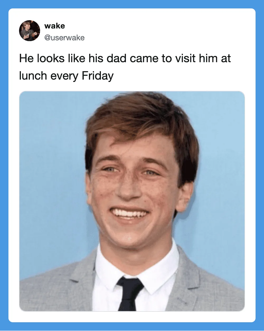 Smiling young man in a suit with a dad-like expression.