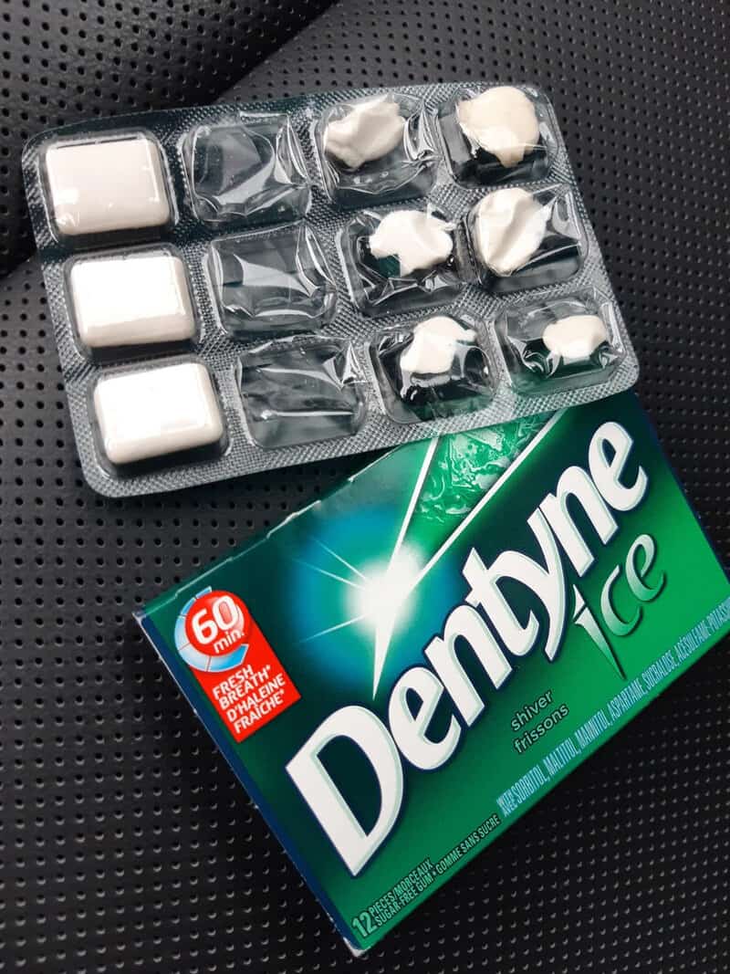 Chewing gum and mints in a blister pack on a car seat.